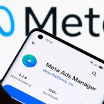 Application Meta Ads Manager affichée sur un smartphone devant le logo Meta