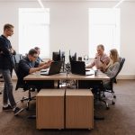 Équipe de prestataire réunie autour d’ordinateurs portables dans un open space