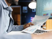Contrôleur de gestion externalisé analysant les graphiques d’un reporting financier devant son écran