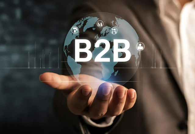 Main ouverte sous un globe terrestre lumineux portant l'inscription B2B